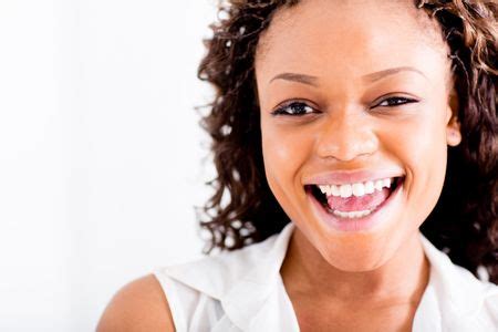 Portrait of a happy African American woman laughing | Freestock photos