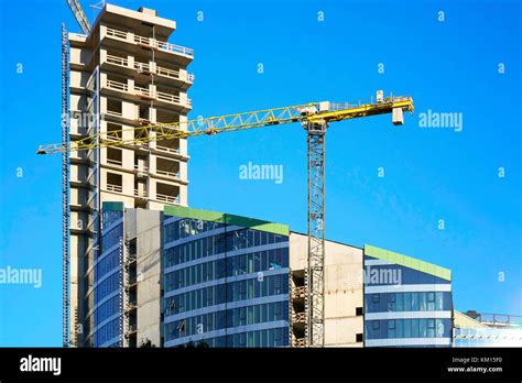 Development of modern steel and glass futuristic forum skyscraper reflecting the blue sky Stock ...