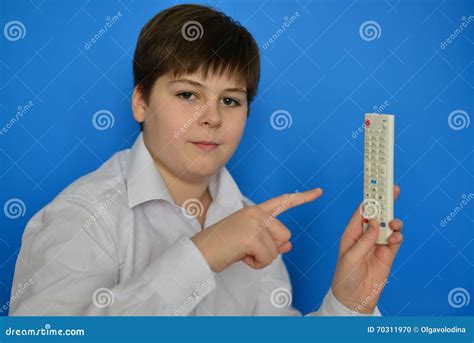 Boy Teenager with TV Remote Control on a Blue Background Stock Photo - Image of button, teenager ...