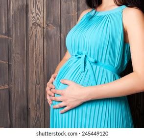 Pregnant Womans Belly On Wood Background Stock Photo 245449120 ...