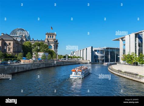 River cruise boat on the Spree River in front of the German parliament buildings, Mitte, Berlin ...