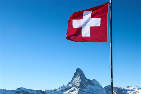Free Stock Photo of Swiss Flag Over Matterhorn Mountain Peak