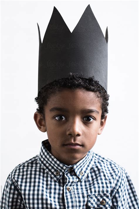 "Portrait Of A Boy Wearing A Black Crown." by Stocksy Contributor "BONNINSTUDIO " - Stocksy