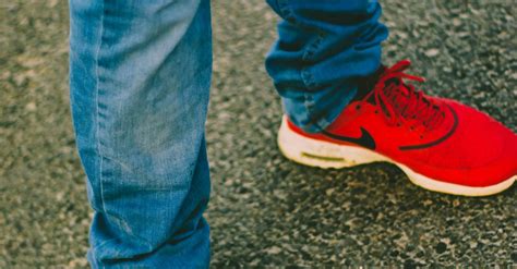 Person Wearing Red Nike Running Shoes · Free Stock Photo