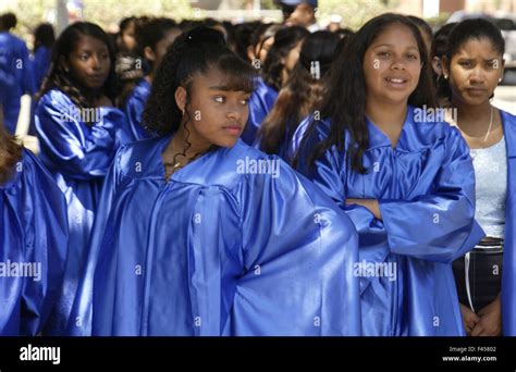 Hispanic and African American middle school girls wearing blue ...