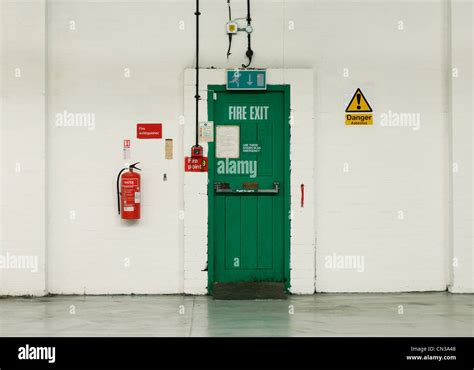 Fire exit door and signs in industrial building Stock Photo, Royalty ...