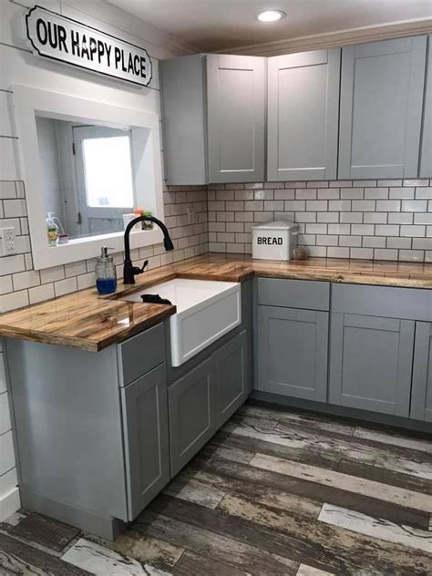 Light gray cabinets, wood floor and butcher block counters in the kitchen. #woodflooringideas ...