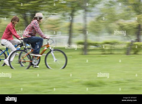 Couple Biking Together Stock Photo - Alamy