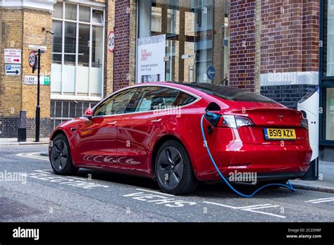 LONDON, JUNE, 2020: A red Tesla Model 3 parked and charging on city street Stock Photo - Alamy