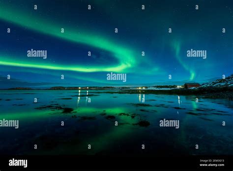 Aurora Borealis on the night sky above the sea. Winter night in Norway ...