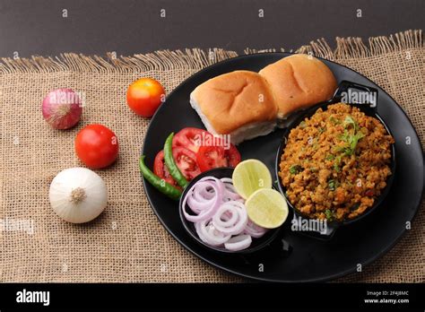 Masala Anda Bhurji or Spicy Indian scrambled eggs with bread or Bun Pav ...