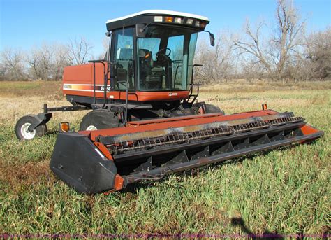 Hesston 8450 swather in Tampa, KS | Item E8173 sold | Purple Wave