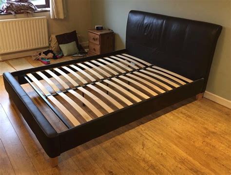 King size, dark brown, faux leather bed frame with integrated headboard. Ready to collect. | in ...