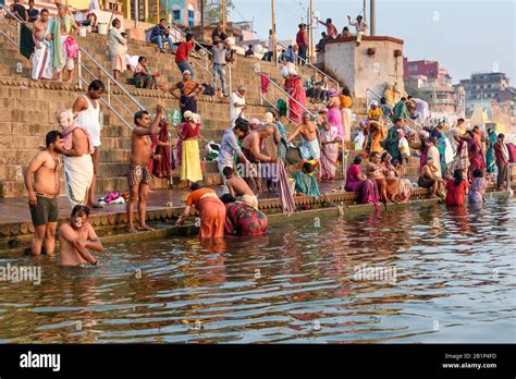 People bathing in water holy Ganga river at Kedar Ghat in morning ...