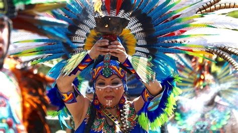 Aztec dancers perform during May Day rally in Seattle | king5.com