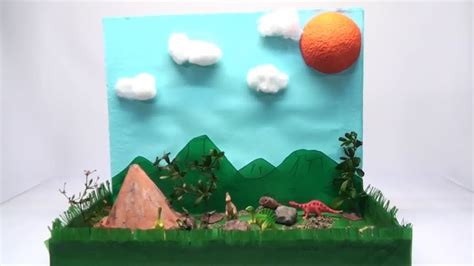 an orange is sitting on top of a green box with grass and rocks in front of it