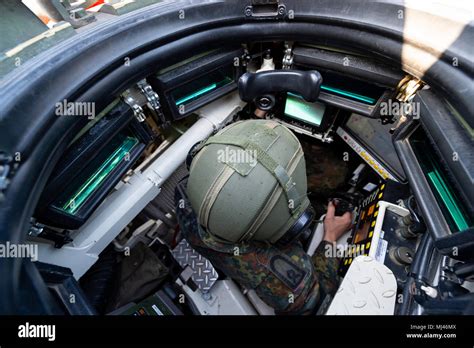 19 April 2018, Germany, Munster: A commander of the Bundeswehr sits inside a battle tank type ...