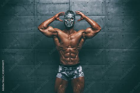 Mysterious Muscular man hiding behind mask Flexing Muscles. Bodybuilder ...