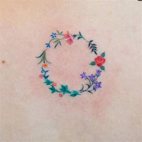 Flower wreath tattoo located on the back.