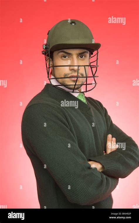 Businessman wearing a cricket helmet Stock Photo - Alamy