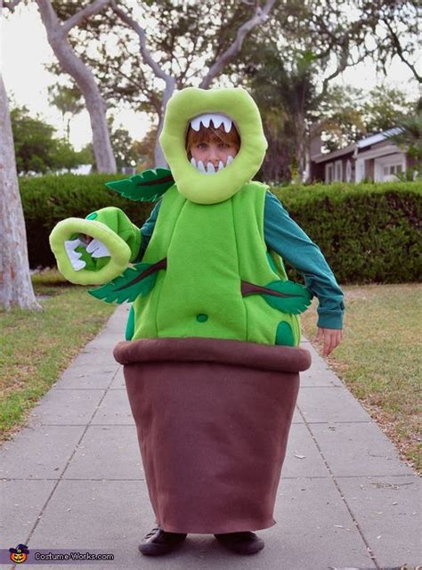 a man in a costume is standing on the sidewalk with his mouth open and ...