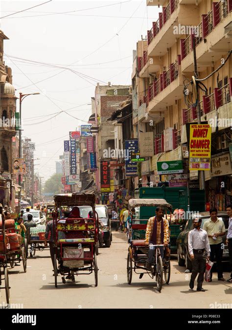 Indian people on Main Bazar Pahar Ganj with tuk tuks passing by ...