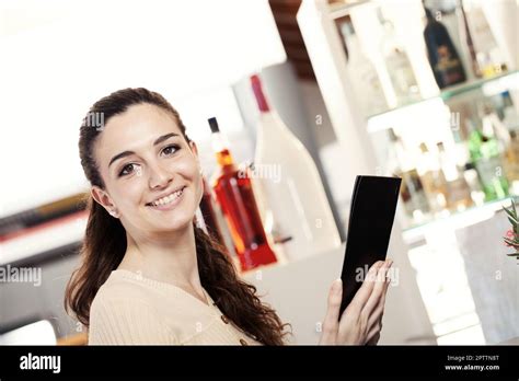 Beautiful young woman at the coffee bar, ice cream shop or pastry shop ...