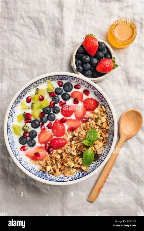 Granola bowl with berries, fruits and natural yogurt. Layered healthy ...