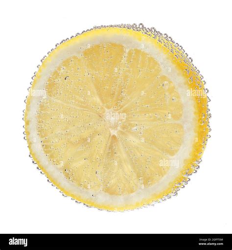 Lemon slice in a water on white background Stock Photo - Alamy