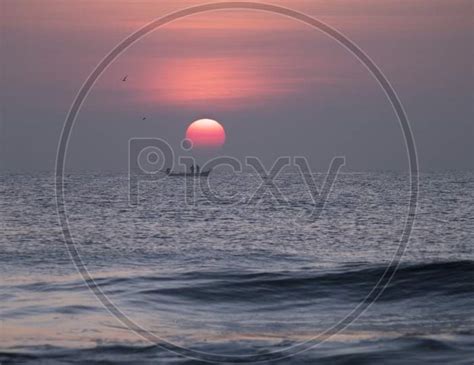 Image of Silhouette Of Fishing Boat On Sea With Sunset Sky In Background-TZ244730-Picxy