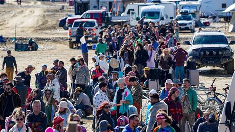 Burning Man festival attendee treks through ankle-deep mud to escape: 'Our only option to get ...