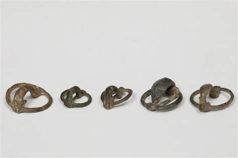 Set of five annular fibulae; Celtiberian culture, Hispania, 3rd-2nd century B.C. Bronze. Three ...