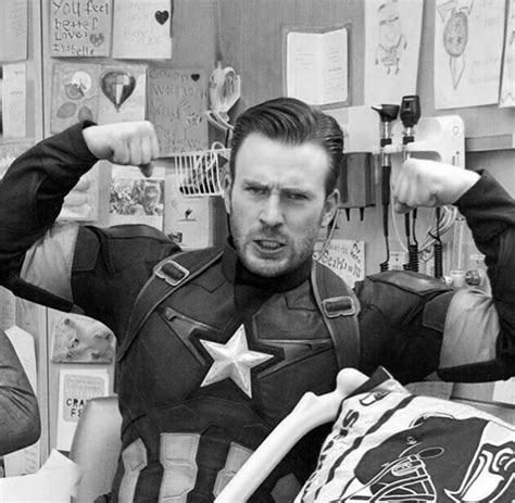 two men dressed as captain america in an office