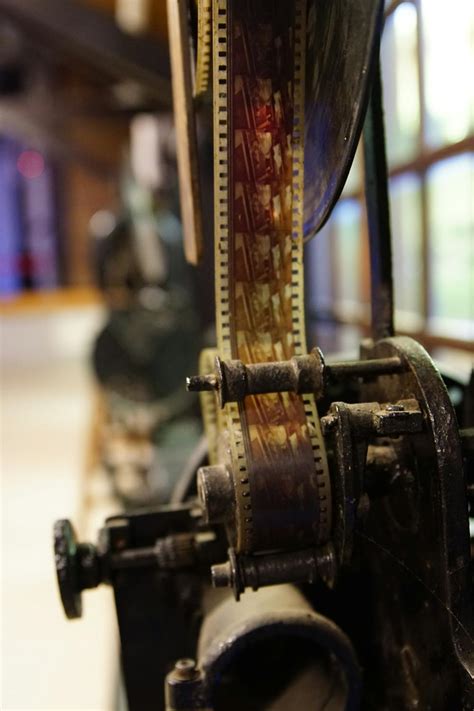 Old movie projector with film roll in museum · Free Stock Photo