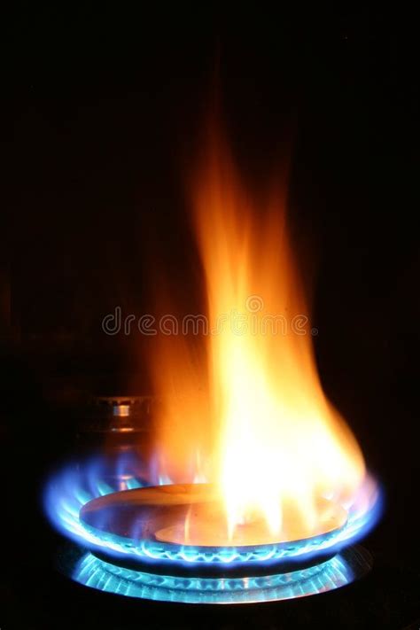 a gas stove with bright blue flames in the dark royalty images and ...