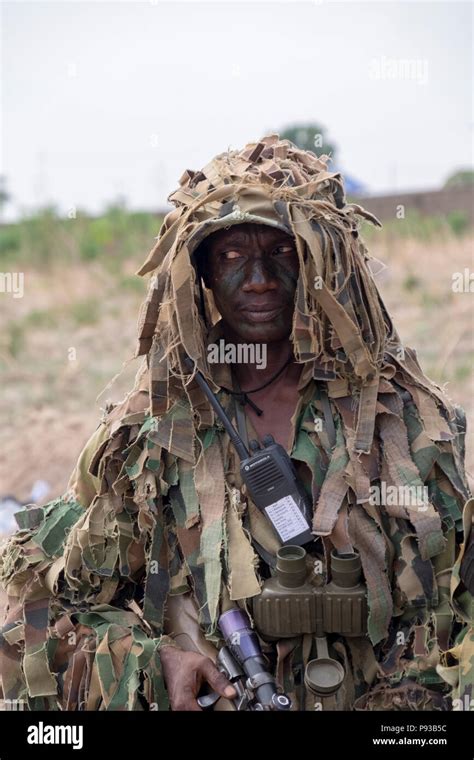 A Nigerian Army special forces sniper poses during a demonstration of ...