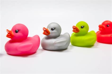 Premium Photo | Colorful rubber ducks isolated on white