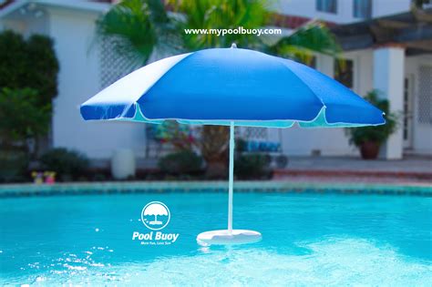 an umbrella sitting in the middle of a pool