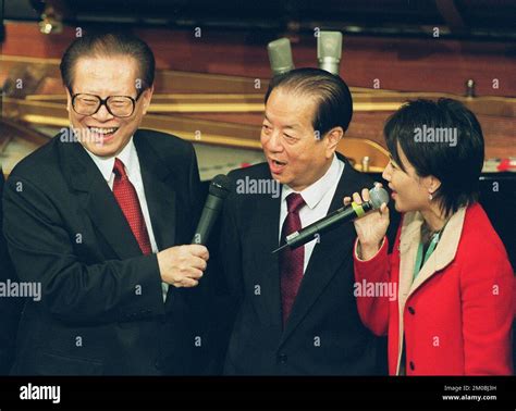 President Jiang Zemin leads singing a song with Vice-premier Qian ...