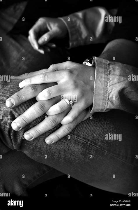 Couple is holding hands in a black and white Stock Photo - Alamy