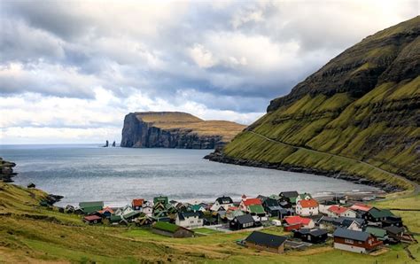 Premium Photo | Tjornuvik village and two sea stacks on faroe islands