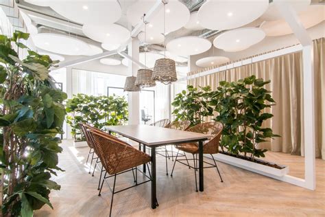 an indoor dining area with plants and chairs