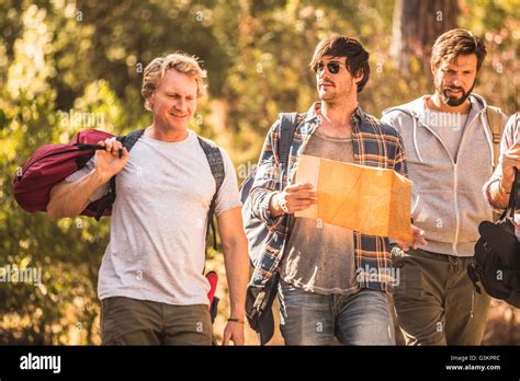 Four male hikers hiking through forest with map, Deer Park, Cape Town, South Africa Stock Photo ...