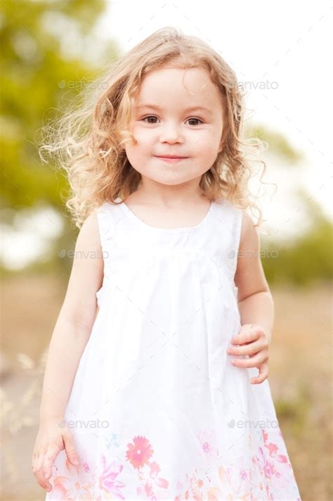 Cute little girl walking in meadow Stock Photo by morrowlight | PhotoDune