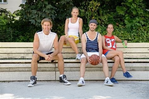 Portrait of basketball players sitting on park bench - Stock Photo ...