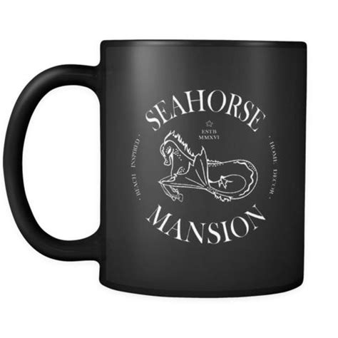 a black coffee mug with the seahorse mansion logo on it