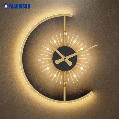 a clock that is on the side of a wall with lights around it and an arrow in the middle