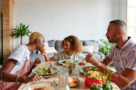 "Laughing Family Having Dinner" by Stocksy Contributor "Ivan Gener"