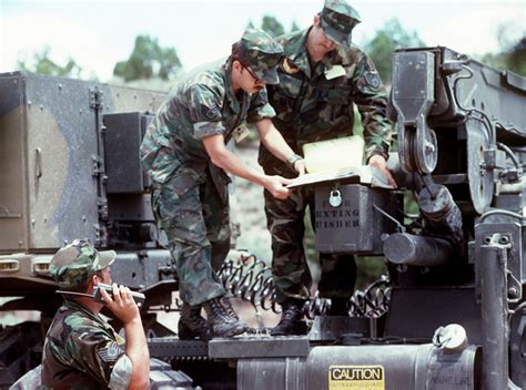 An American Flag hangs between two AN/TRC-170 Tactical Digital ...