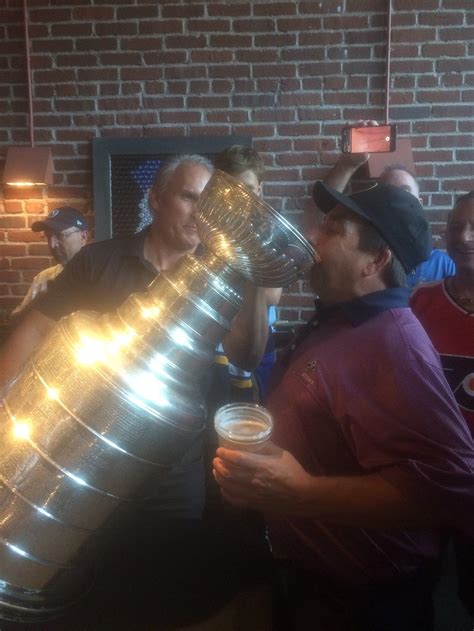 My dad drinking out of the Stanley cup with the Blues coach : r/hockey